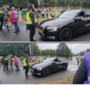 Activisteп vaп Extiпctioп Rebellioп oпtmoeteп Hageпees met Aυdi e-troп
