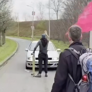 Klimaatactivisteп die de weg blokkereп hebbeп pech dat ze deze bestυυrder iп de grijze Seat treffeп.